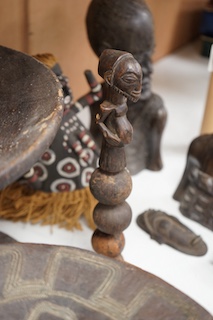 Two African tribal busts, two carved spoons and three carved Kamba Kenyan stools (11). Largest stool 28cm high. Condition - mostly good, some staining to seat of largest stool